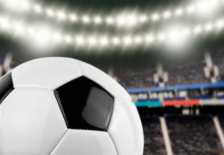 cropped shot of soccer ball at the football stadium with the spotlights illuminating the field