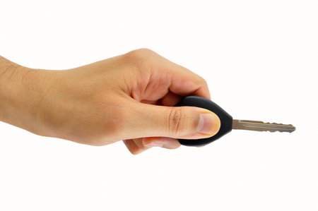 man holding a car key with remote  isolated on whiteの写真素材