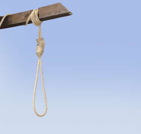 the gallows with noose shows the method of execution or suicide isolated with sky backgroundの写真素材