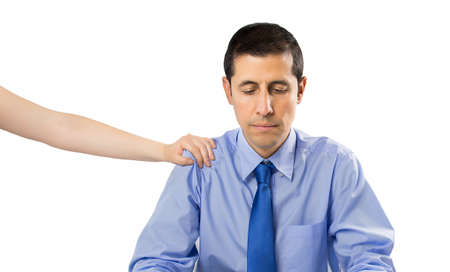 clerk demotivated after a failure and discussion with hand of coleague on his shoulder giving support isolated with white backgroundの写真素材