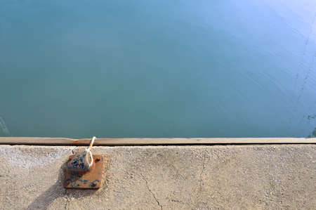 detail of moorage with rope of the boat at the pier with copy spaceの写真素材