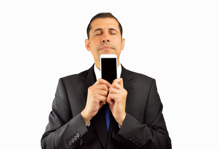 Businessman dreaming with a new business call holding his smartphone isolated on a white backgroundの写真素材