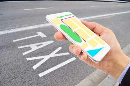 Top view of business man walking in the street using her mobile phone with taxi service in the...