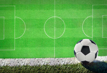 Soccer ball on grass field backgroundの写真素材