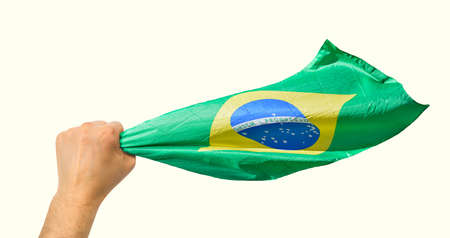 Brazilian fan holding the flag of Brazil isolate with white backgroundの写真素材