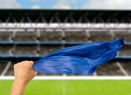 Fan holding the flag at stadium.International soccer event