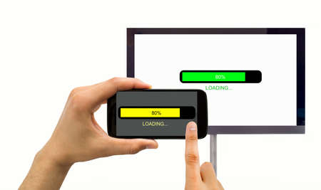 closeup of a smartphone connected to a tv and loadiong datasの写真素材