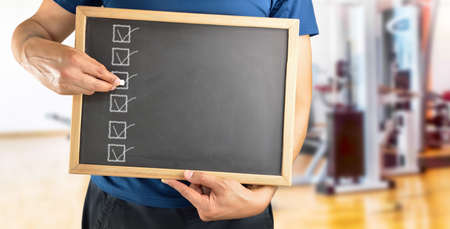 Coach with a blackboard with a list and copy spaceの写真素材