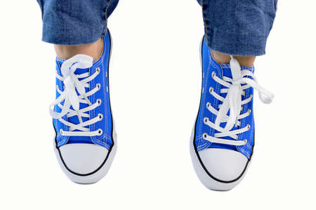 Cropped image of a person wearing sneakers standing on their toes isolated with white backgroundの写真素材
