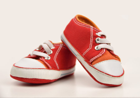 Pair of baby sneakers on white background