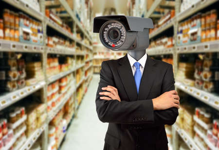 management surveillance at the warehouse with a man wearing a surveillance camera as headの写真素材