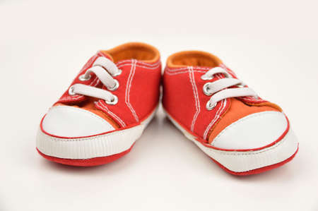 Pair of baby sneakers on white backgroundの写真素材