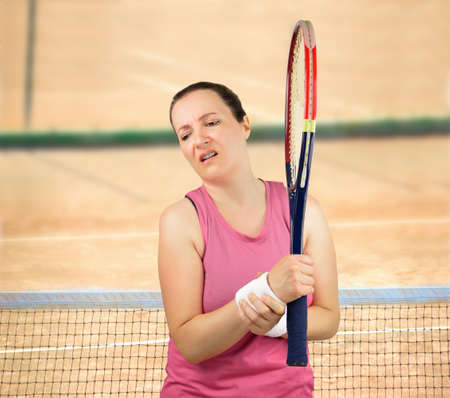 shot of a tennis player with a wrist injury on a clay courtの写真素材