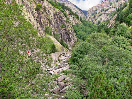 A narrow stone bridge in mountain area in the northern part of Spain, Pyrenees cataloniaの写真素材