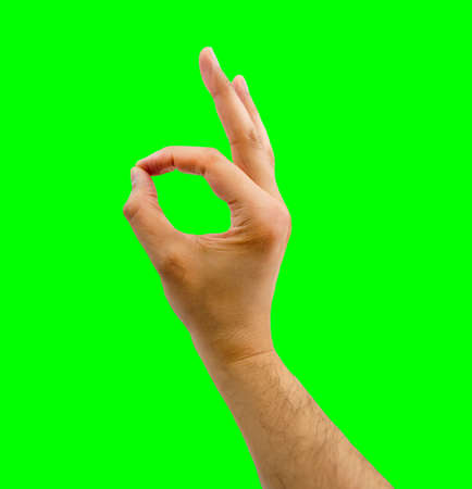 the hand of man gesturing OK  isolated cutout on green background with chroma key の写真素材