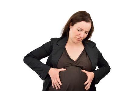 Pregnant woman suffering belly ache isolated with white backgroundの写真素材