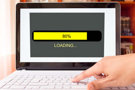 detail of man pushing and loading of the laptop at homeの写真素材