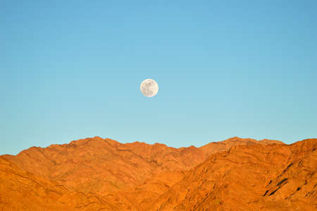 sunset in Aqaba with sinai mountains of egypt and moon backgroundの写真素材