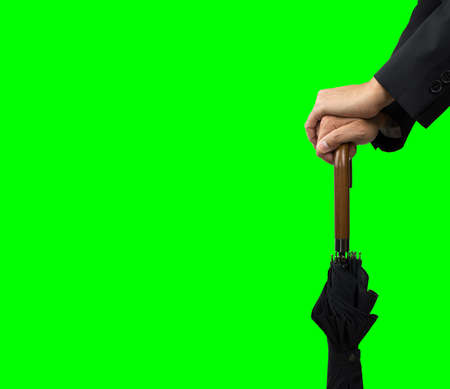 Cropped shot of a hands on an umbrella with chroma keyの写真素材