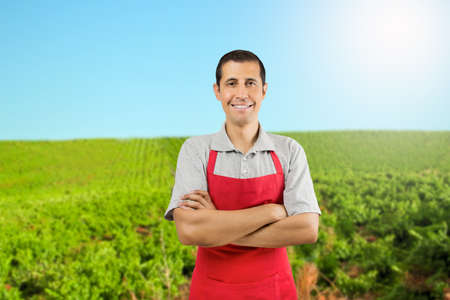 Portrait of a happy farmer posing with his arms crossed in a vineyard at Spainの写真素材