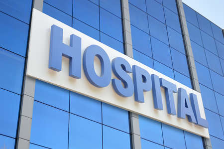 Hospital building sign closeup, with sky reflecting in the glass. 3d renderingの写真素材