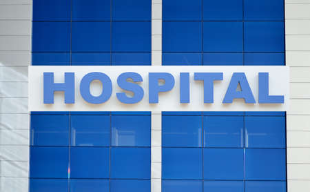 Hospital building sign closeup, with sky reflecting in the glass. 3d renderingの写真素材