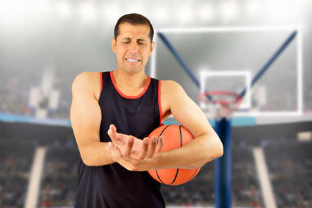 basketball player with a wrist injury at stadiumの写真素材