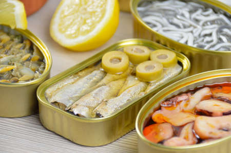 Assortment of cans of canned with different types of fish and seafoodの写真素材