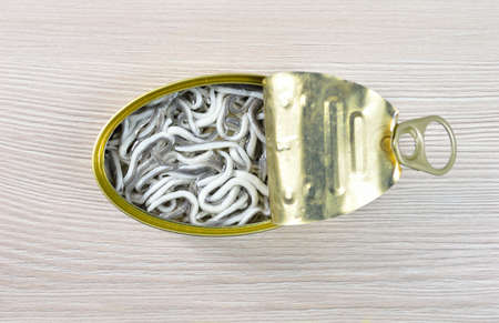 High angle shot of delicious can of preserved eels on on rustic wooden tableの写真素材