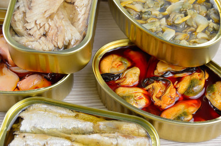 Assortment of cans of canned with different types of fish and seafood