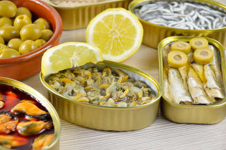 Assortment of cans of canned with different types of fish and seafoodの写真素材