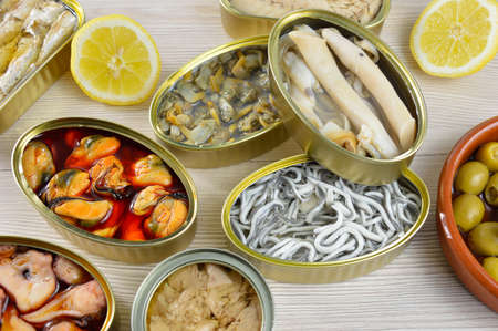 Assortment of cans of canned with different types of fish and seafoodの写真素材