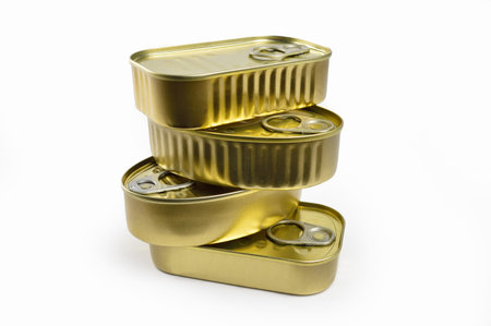 Collection of cans of canned unopened fish on white background