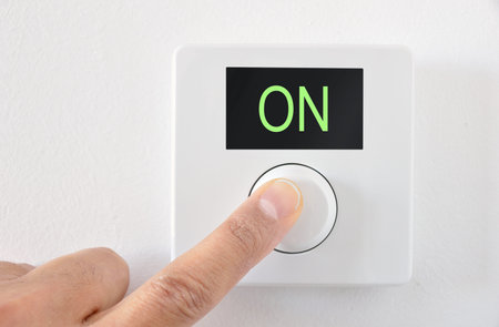 digital thermostat with finger pressing button the On start