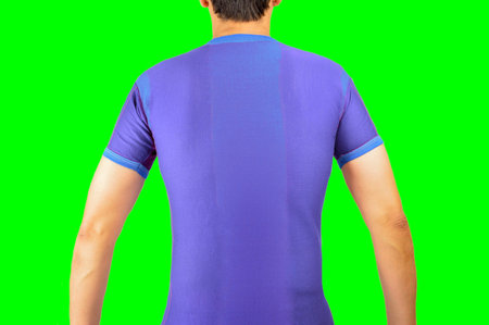 back of a football player with blue t-shirt.Isolated cutout on green background with chroma...