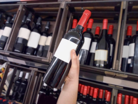 Woman holding one bottle of wine at the supermarket
