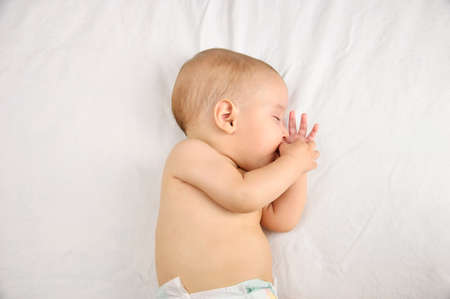 Cropped shot of an adorable baby boy taking a napの写真素材