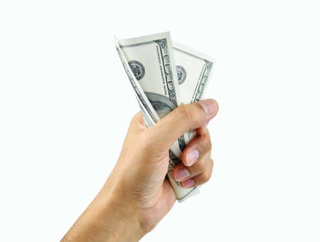 Close up of a man's hand crushing a wad of hundred dollar notes while isolated on a white backgroundの写真素材