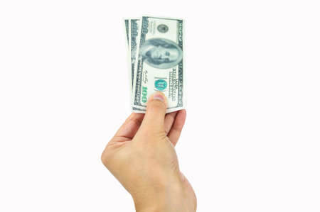 Close-up hand holding us dollars isolated cutout on white backgroundの写真素材