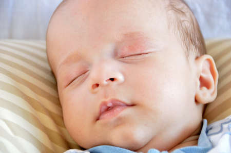 Cropped shot of an adorable baby boy taking a napの写真素材