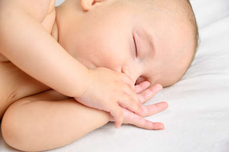 Cropped shot of an adorable baby boy taking a napの写真素材