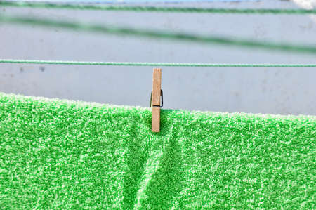 Wooden clothespin with the towel on at homeの写真素材