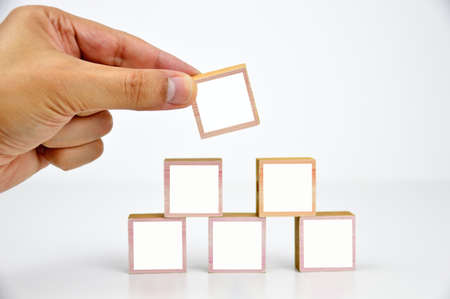 Hand arranging block stacking as building. Business concept for growth success process with copy spaceの写真素材
