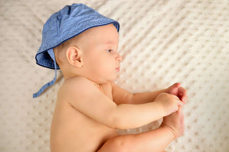High angle shot of a cute baby lying on a bedの写真素材