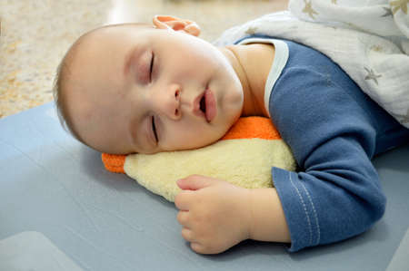 Cropped shot of an adorable baby boy taking a napの写真素材