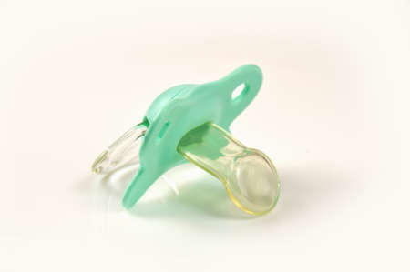 Green baby's pacifier isolated on white backgroundの写真素材