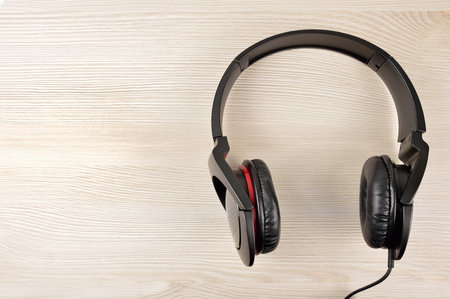 Black headphones on wooden table close-upの写真素材