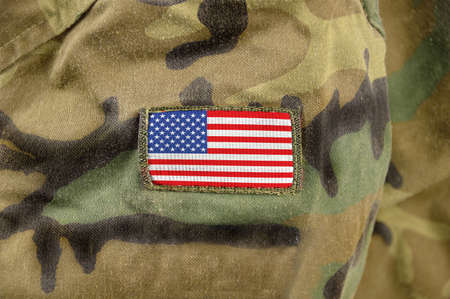 Cropped closeup shot of the United States of America flag on a soldier's uniformの写真素材