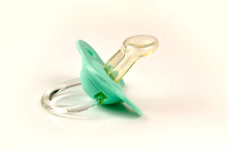 Green baby's pacifier isolated on white backgroundの写真素材