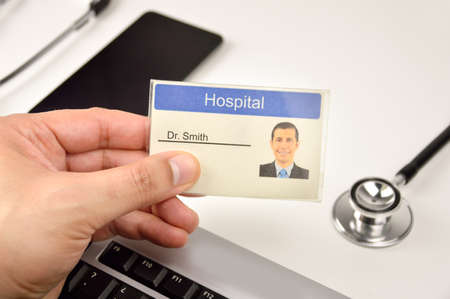 Shot of a hand doctor holding up a identification doctor sign at hospitalの写真素材